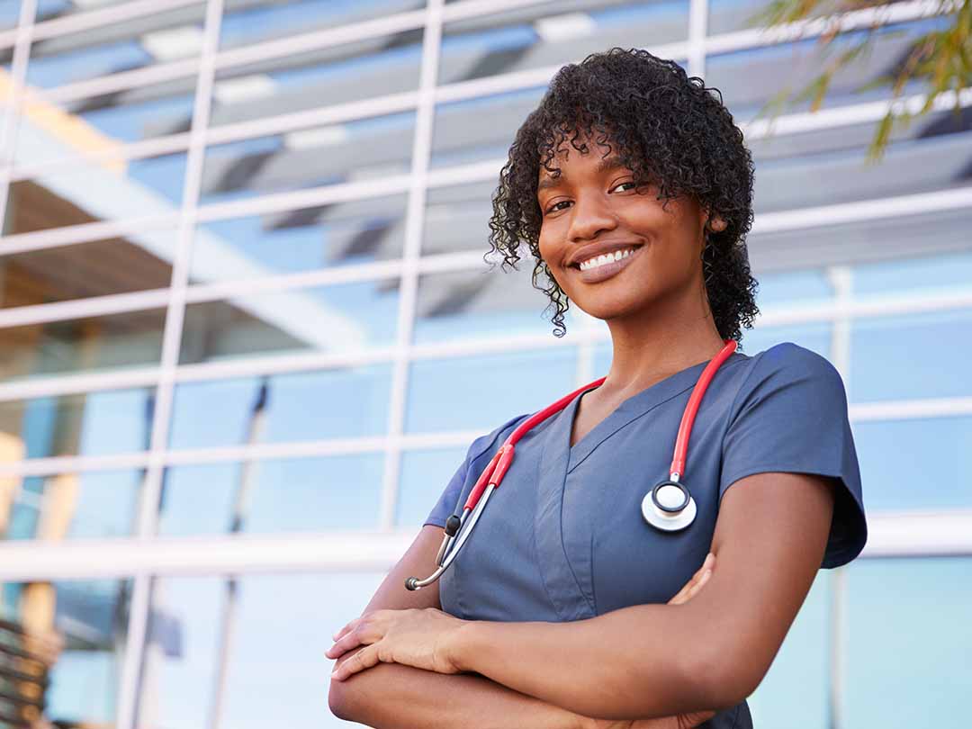 An afro-american young nurse smiling at the camera
